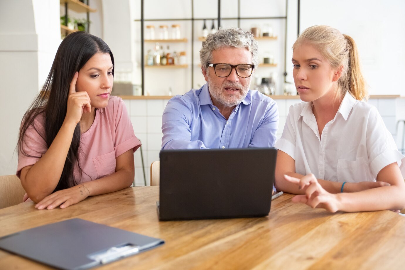 focused-pensive-young-woman-mature-man-meeting-with-female-professional-watching-discussing-content-laptop_74855-9922